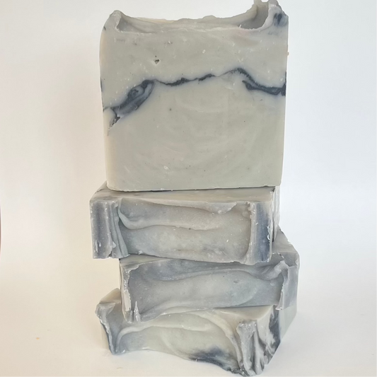 Handgemaakte blauwgrijze Anise Allure zeep, voedend met olijfolie, sheaboter en castorolie, verrijkt met actieve kool voor een stralende huid en een karaktervolle, kruidige geur.